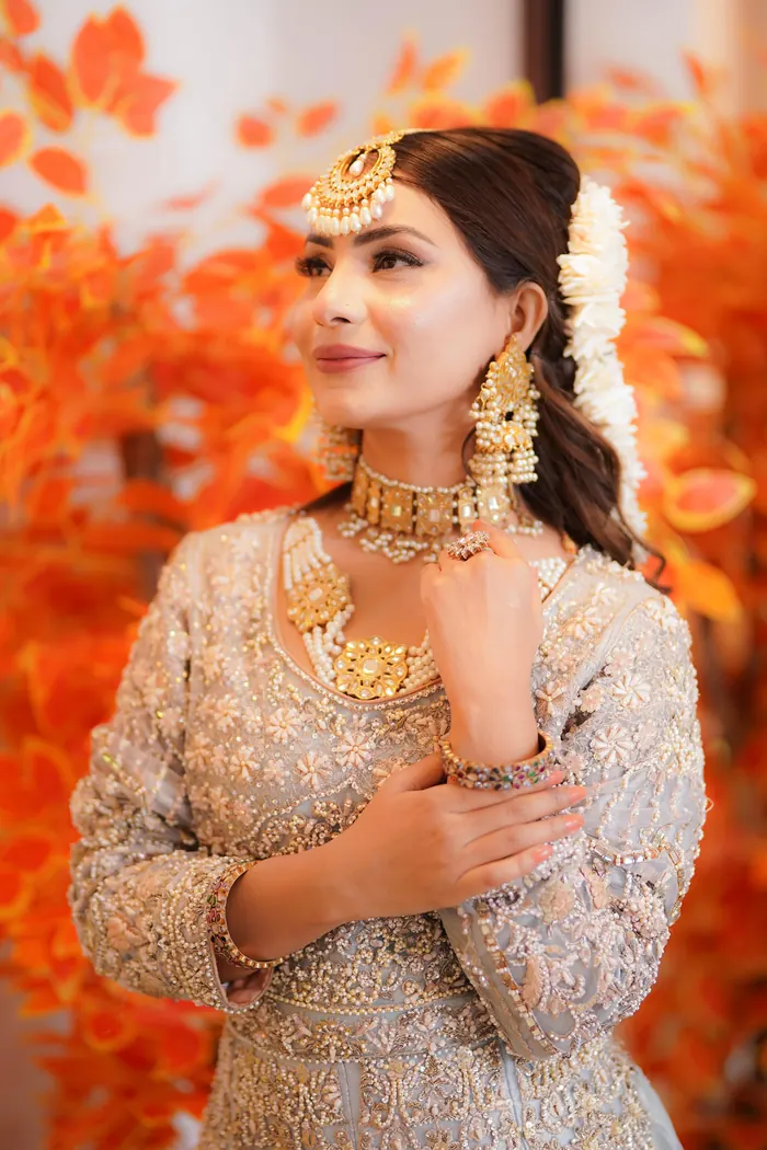 Bride in burnt orange with a heavy dupatta