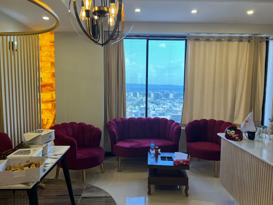 The Bi Rose lounge with velvet chairs and tall windows